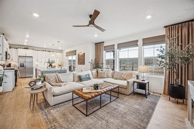 living area featuring recessed lighting, visible vents, ceiling fan, and light wood finished floors