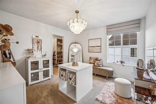 office space with light carpet, a notable chandelier, and baseboards