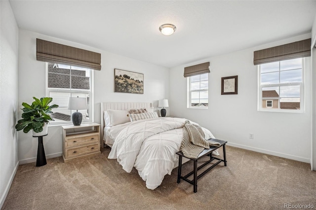 carpeted bedroom featuring baseboards