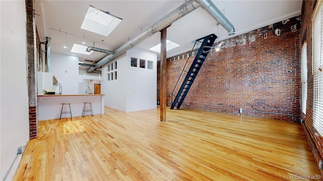 1510 Wazee St Unit 3, Denver, CO 80202 - basement with brick wall and hardwood / wood-style floors