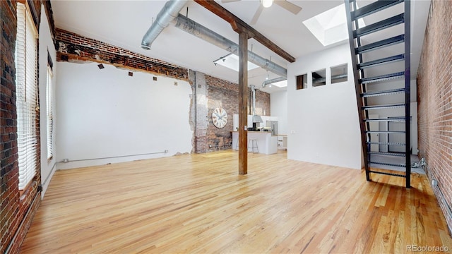 1510 Wazee St Unit 3, Denver, CO 80202 - below grade area featuring brick wall, wood finished floors, and ceiling fan