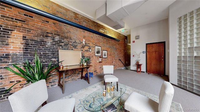 1510 Wazee St Unit 3, Denver, CO 80202 - carpeted living area with brick wall and a towering ceiling