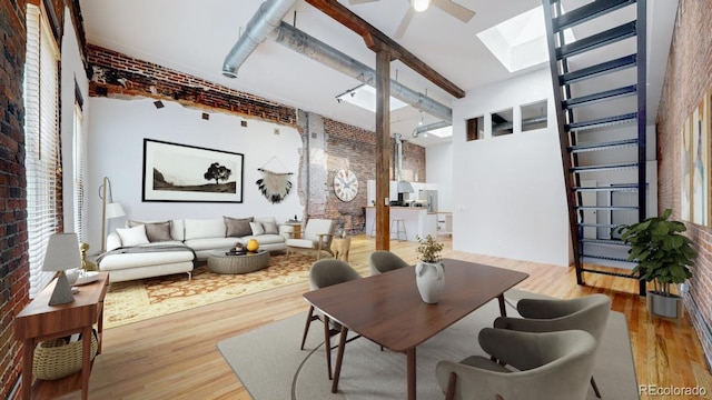 1510 Wazee St Unit 3, Denver, CO 80202 - dining area featuring brick wall, a skylight, light wood-style flooring, a ceiling fan, and a high ceiling