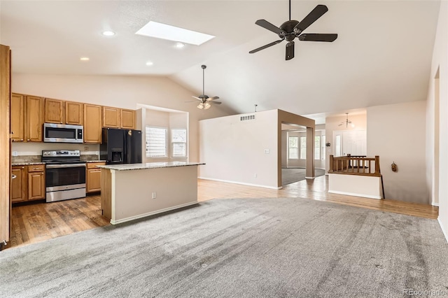 2307 S Ensenada St, Aurora, CO 80013 - kitchen featuring appliances with stainless steel finishes, plenty of natural light, a kitchen island, a ceiling fan, and high vaulted ceiling