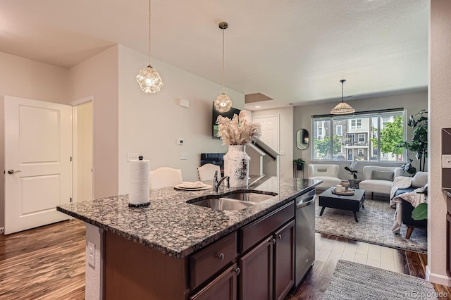 504 E Dry Creek Pl, Littleton, CO 80122 - kitchen with a sink, dark wood-style floors, stainless steel dishwasher, and dark stone countertops