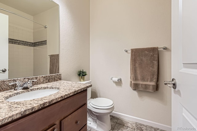 504 E Dry Creek Pl, Littleton, CO 80122 - bathroom with vanity, toilet, baseboards, and a shower