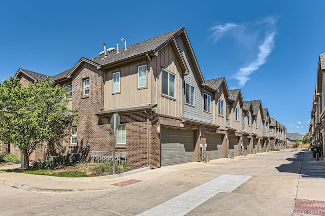 504 E Dry Creek Pl, Littleton, CO 80122 - view of property with a residential view, an attached garage, driveway, and cooling unit