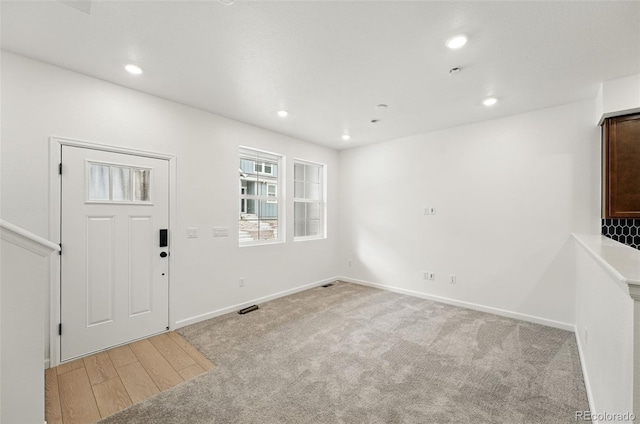 17117 W 91st Ln, Arvada, CO 80007 - empty room featuring baseboards, recessed lighting, light carpet, and light wood-type flooring