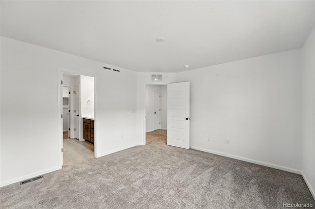 17117 W 91st Ln, Arvada, CO 80007 - unfurnished bedroom featuring light carpet, baseboards, and connected bathroom