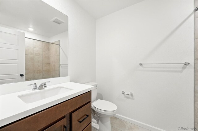 17117 W 91st Ln, Arvada, CO 80007 - full bath featuring toilet, baseboards, vanity, tile patterned floors, and a shower