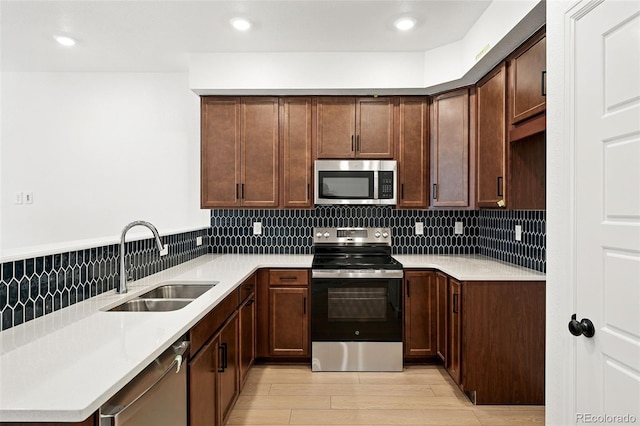 17117 W 91st Ln, Arvada, CO 80007 - kitchen with stainless steel appliances, a sink, decorative backsplash, light countertops, and recessed lighting