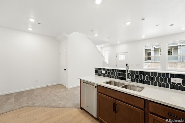 17117 W 91st Ln, Arvada, CO 80007 - kitchen with dishwasher, a sink, light wood-style flooring, backsplash, and light countertops