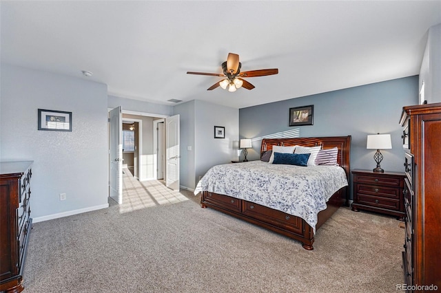 carpeted bedroom featuring baseboards and a ceiling fan