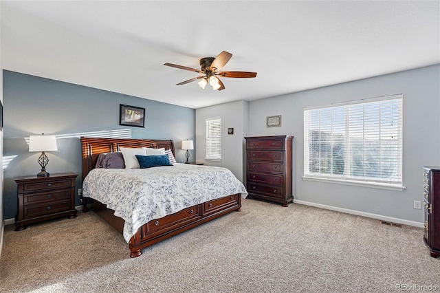 bedroom with light carpet, baseboards, and a ceiling fan