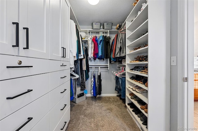 walk in closet with carpet flooring