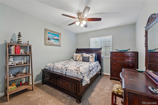 carpeted bedroom featuring baseboards and a ceiling fan