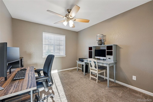 office space featuring carpet flooring, baseboards, and ceiling fan