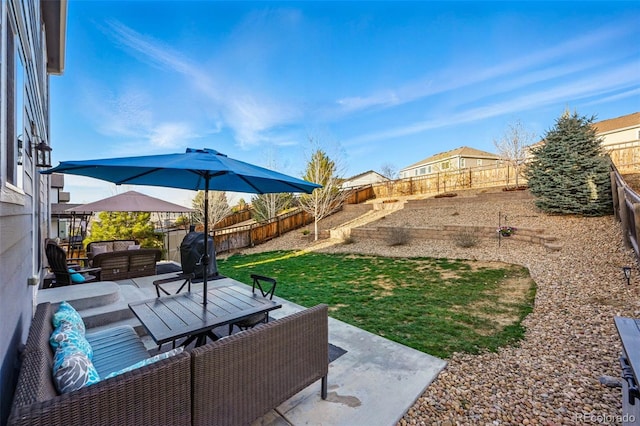 view of yard featuring a fenced backyard, a patio, and an outdoor hangout area