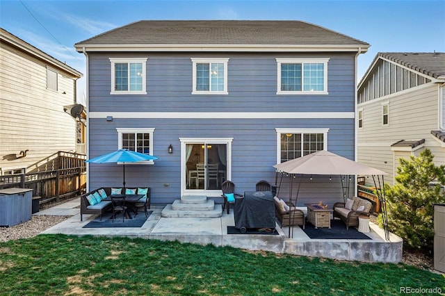 back of property with a patio, a yard, fence, and an outdoor living space with a fire pit