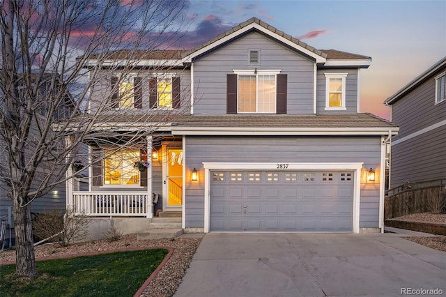traditional home with concrete driveway, fence, an attached garage, and a tile roof