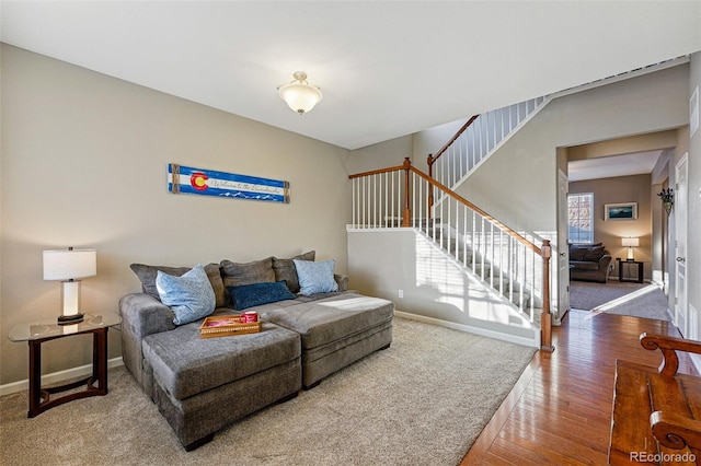 living room with stairway, baseboards, and wood finished floors
