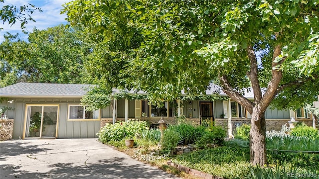 1315 Tipperary St, Boulder, CO 80303 - view of front of home with board and batten siding and a shingled roof