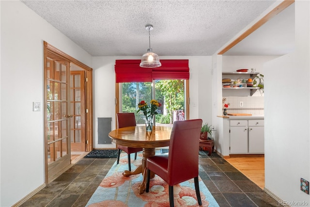 1315 Tipperary St, Boulder, CO 80303 - dining space with stone tile floors and a textured ceiling