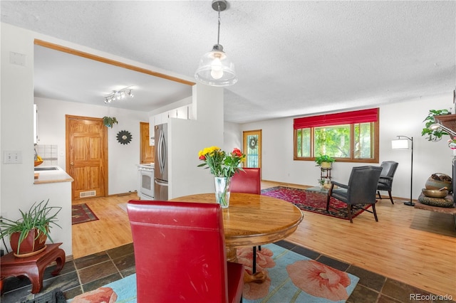 1315 Tipperary St, Boulder, CO 80303 - dining area with a textured ceiling and dark wood-style flooring