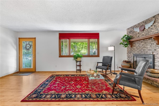 1315 Tipperary St, Boulder, CO 80303 - living area with a textured ceiling, wood finished floors, and a brick fireplace