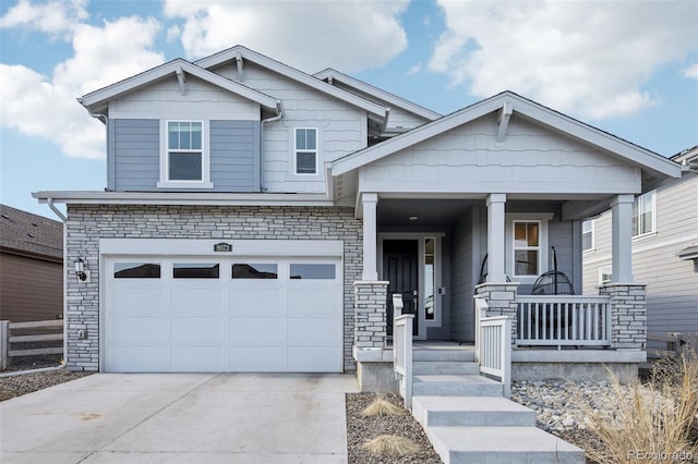 craftsman-style house with a garage, covered porch, and concrete driveway