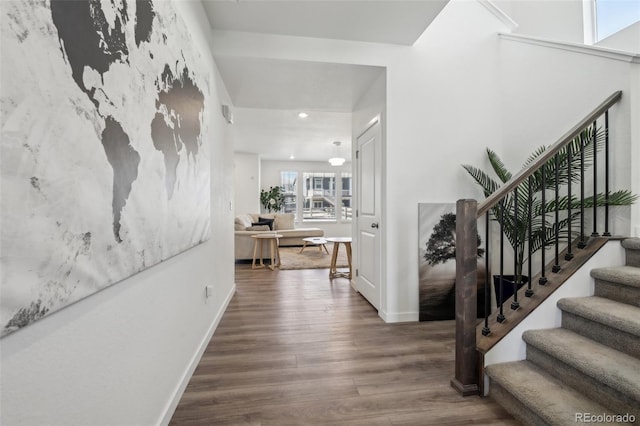 entrance foyer with recessed lighting, stairway, baseboards, and wood finished floors