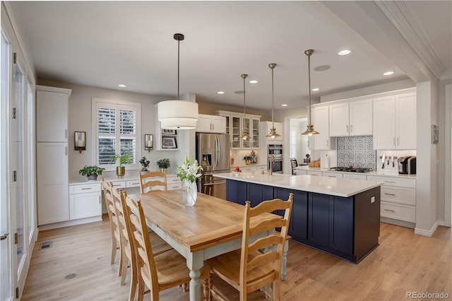 dining area featuring light wood finished floors and recessed lighting