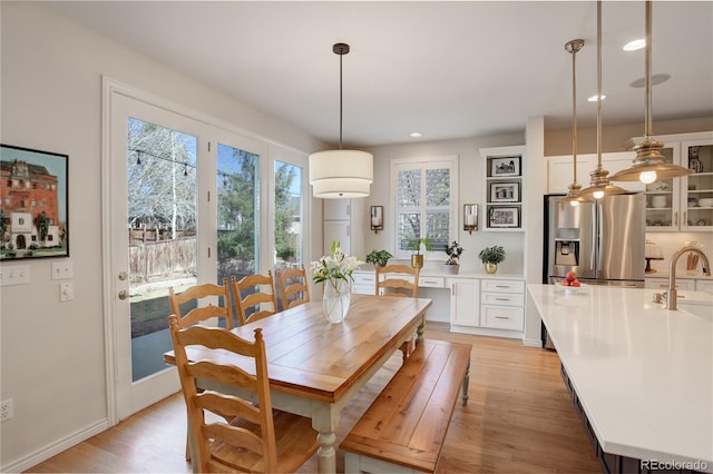 dining area featuring recessed lighting and light wood-style flooring