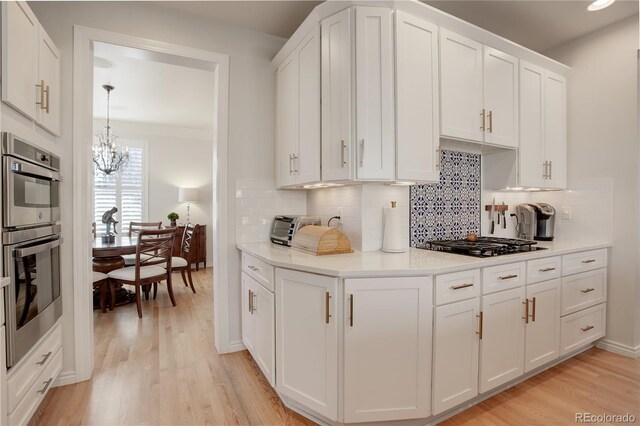 kitchen featuring white cabinets, black gas stovetop, and light wood finished floors