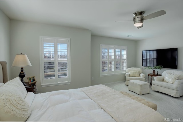 bedroom featuring ceiling fan, multiple windows, carpet flooring, and baseboards