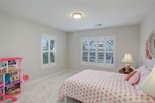 carpeted bedroom with visible vents and baseboards