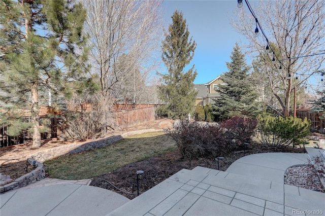 view of yard featuring a patio and fence