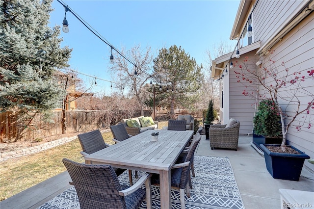 view of patio with outdoor dining area, outdoor lounge area, and fence