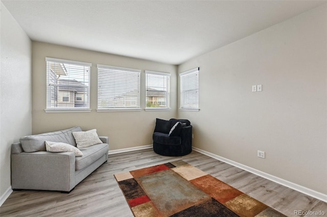 13113 W 73rd Ave, Arvada, CO 80005 - living area with baseboards, a healthy amount of sunlight, and light wood-style flooring