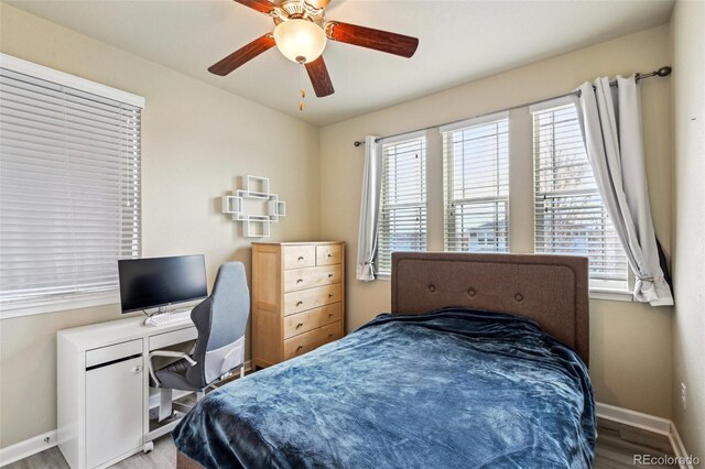 13113 W 73rd Ave, Arvada, CO 80005 - bedroom with a ceiling fan, baseboards, multiple windows, and wood finished floors