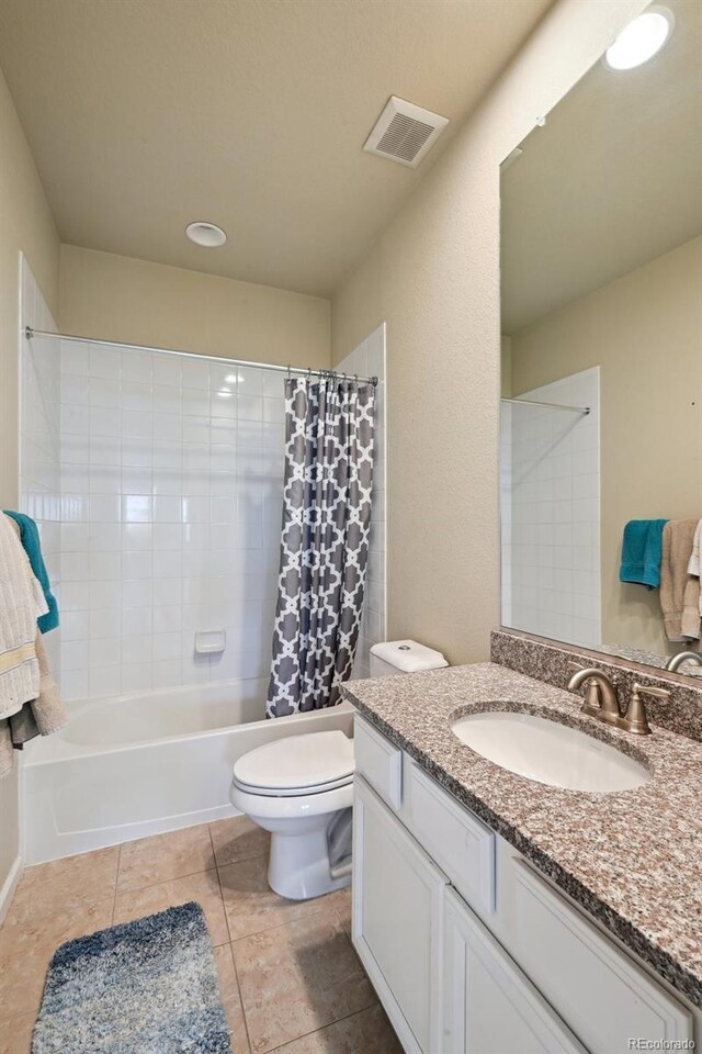 13113 W 73rd Ave, Arvada, CO 80005 - full bathroom featuring tile patterned floors, vanity, toilet, visible vents, and shower / bath combination with curtain