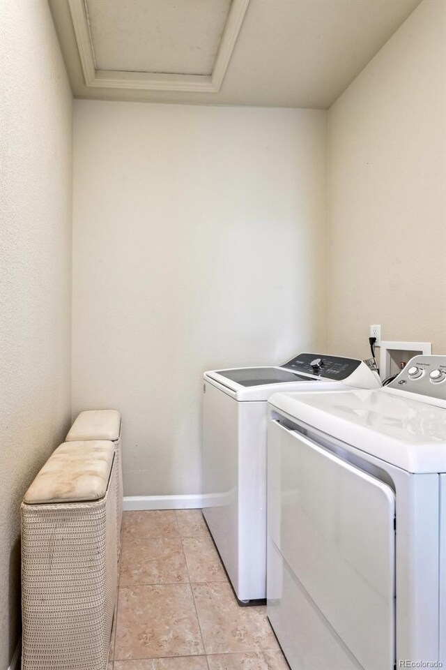 13113 W 73rd Ave, Arvada, CO 80005 - laundry area featuring baseboards, washer and clothes dryer, and laundry area