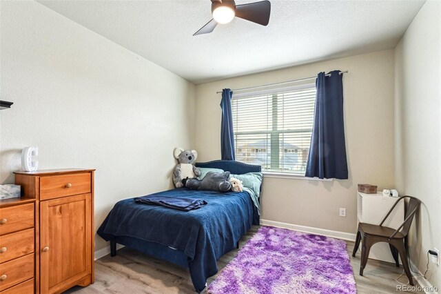 13113 W 73rd Ave, Arvada, CO 80005 - bedroom featuring baseboards, a ceiling fan, and light wood finished floors