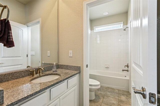 13113 W 73rd Ave, Arvada, CO 80005 - bathroom with tile patterned flooring, toilet, vanity, and shower / washtub combination