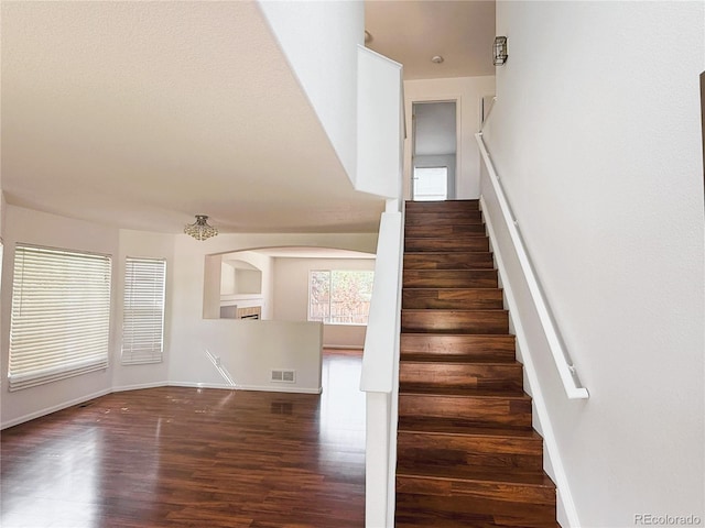 20401 E Chenango Pl, Aurora, CO 80015 - staircase featuring wood finished floors and arched walkways