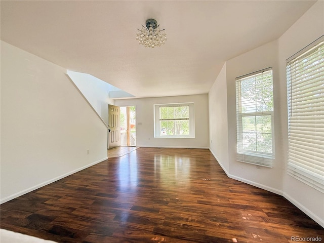 20401 E Chenango Pl, Aurora, CO 80015 - unfurnished living room with wood finished floors and a chandelier