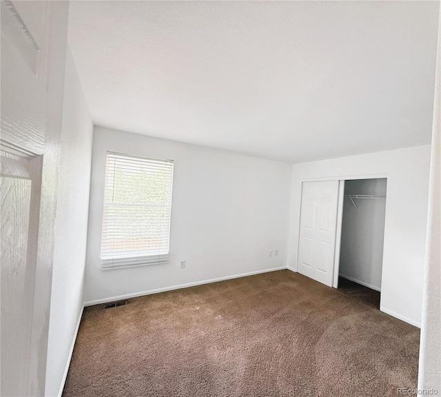 20401 E Chenango Pl, Aurora, CO 80015 - unfurnished bedroom featuring dark colored carpet and a closet