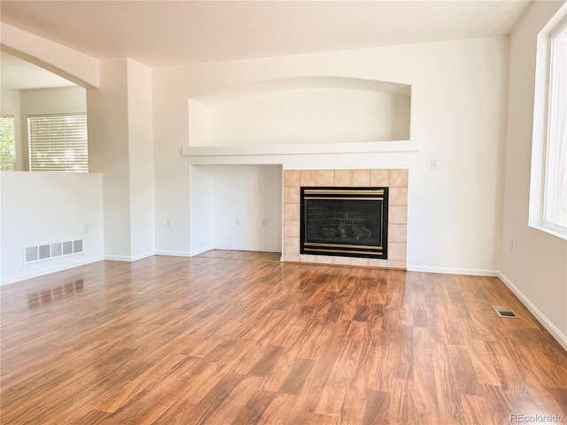20401 E Chenango Pl, Aurora, CO 80015 - unfurnished living room with wood finished floors and a tiled fireplace