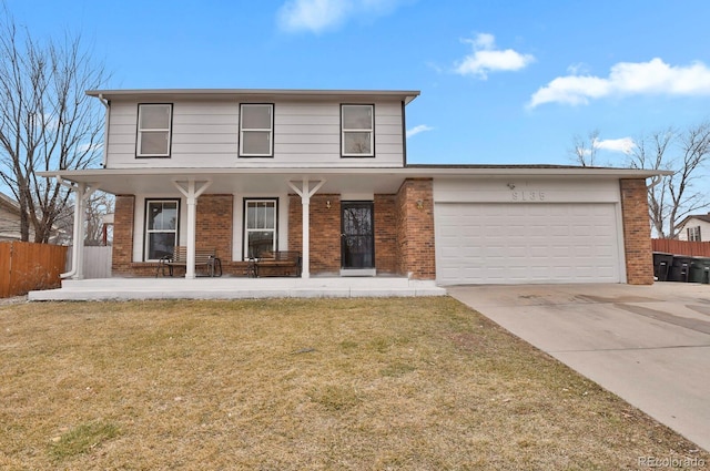 traditional-style home featuring concrete driveway, brick siding, an attached garage, and fence