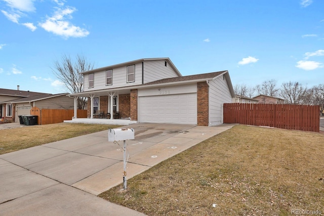 traditional home with a front lawn, brick siding, driveway, and an attached garage